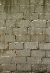 Texture of brick wall from relief stones under bright sunlight