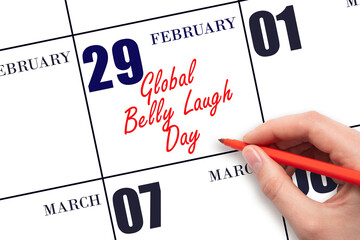 February 29. Hand writing text Global Belly Laugh Day on calendar date. Save the date.