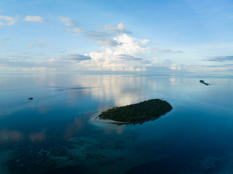 Early morning light illuminates the remote island of Koon near Seram, Indonesia. This scenic island's coral reefs, and the surrounding seas, support extraordinary marine biodiversity.