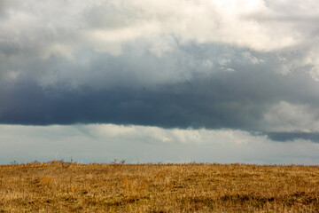 Fototapeta premium Clouds over the field