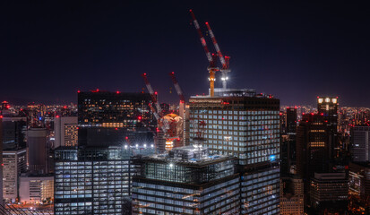 aerial view on construction work on top of skyscrapers at night