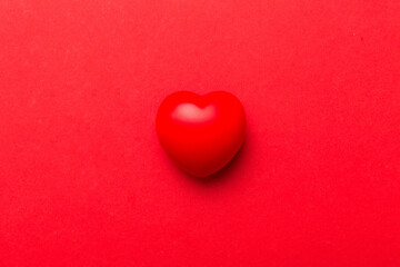 red heart shape on colored background. minimal concept top view with copy space
