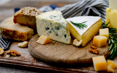 Cheese Plate With Nuts And Honey Is Laid Out On A Wooden Board - obrazy, fototapety, plakaty