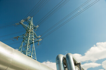 pipeline and power lines against the blue sky