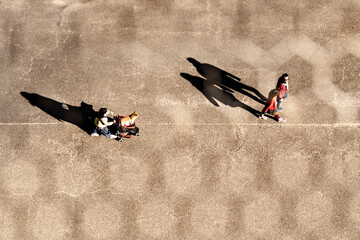 top aerial view of people walking in work time at pedestrian plaza in autumn season. with lighting and shadow. Silhouette people concept