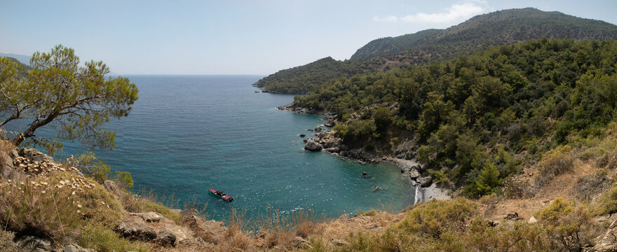 A wide blue lagoon on the Mediterranean coast of Turkey. Top view from high cliff of Burgas Beach which close to Abandoned Village of Kayakoy.