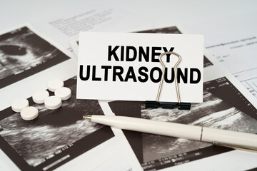 On the ultrasound pictures there is a pen and a business card with the inscription - Kidney...