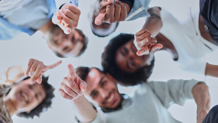 Closeup portrait, bottom view, happy faces of different team employees standing in circle