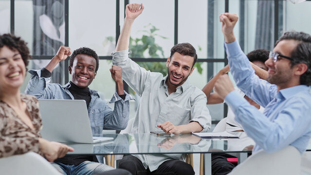 Best team ever. Portrait of extremely happy multinational coworkers are standing in office