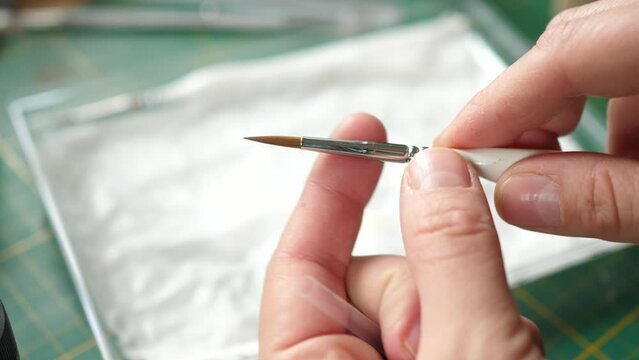 showing small kolinsky fine detail sable brush for painting tabletop minis, miniatures for rpg game