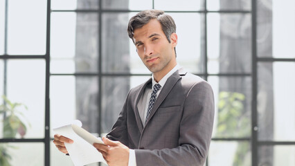 Portrait of a handsome young business man holding document folder