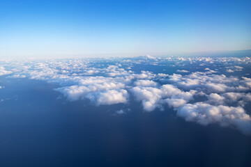 Fototapeta na wymiar Rare white fluffy clouds, top view, in the evening sky