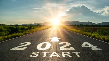 New year 2024 or start straight concept.word 2024 written on the road in the middle of asphalt road at sunset.Concept of planning and challenge or career path,business strategy,opportunity and change - obrazy, fototapety, plakaty