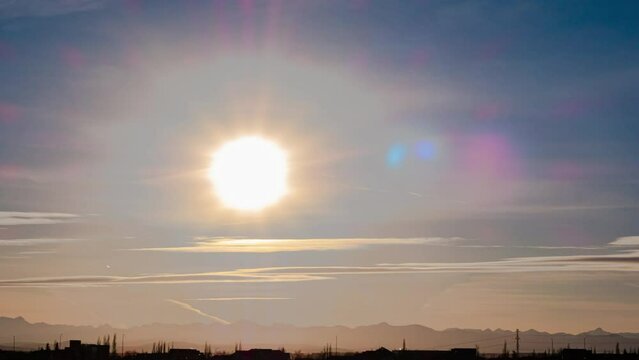 Time-lapse Amazing bright colorful sun radians shining on blue sky, beautiful mountain line up at background. natural landscape 4k resolution footage.