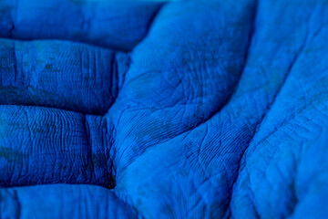 Blue painted hands with texture of skin as background with copy space