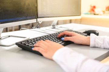 girl working at office on keyboard 