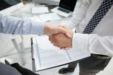 Closeup male people car salesman or sales manager offers to sell a car and explains and reads the terms of signing a car contract and insurance.