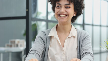 girl in the office smiles expresses success and leadership is thinking about success