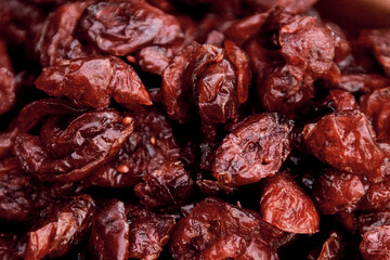Dried and bright cranberries, stacked to highlight their color and texture