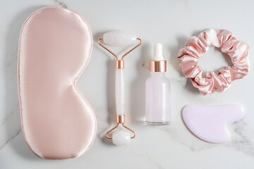 Relax composition with sleep mask, lavender oil and and face treatment massager kit on marble...
