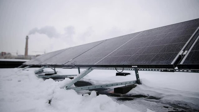 Solar panel and thermal power plant in one shot. From traditional source of energy to alternative renewable energy. Small depth of field, ficus and accent on solar panel