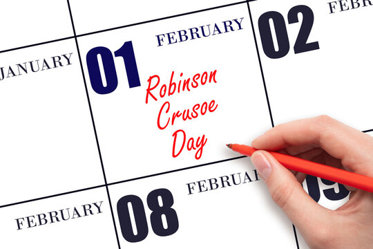 February 1. Hand writing text Robinson Crusoe Day on calendar date. Save the date.