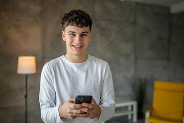 One man caucasian male teenager boy use smartphone mobile phone for online internet browsing social...