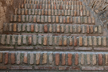 Section of a staircase made from multi-colored clay bricks