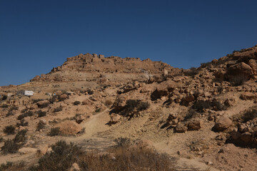 Chenini deserted hilltop old berbere town in Tunisia against blue sky, Africa