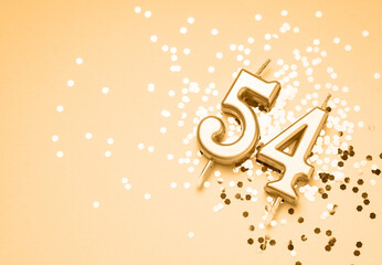 54 years celebration festive background made with golden candle in the form of number Fifty-four...