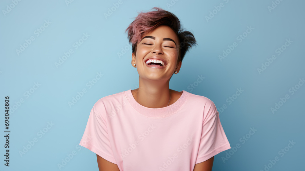 Canvas Prints Happy girl wearing a pink t-shirt, smiling against a blue background