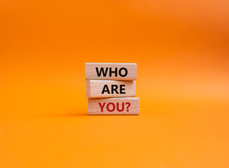 Who are You symbol. Concept words Who are You on wooden blocks. Beautiful orange background....