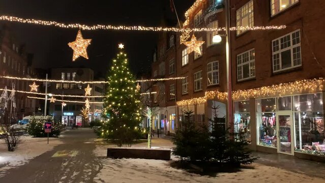  Decorated for Christmas holidays, Denmark, Copenhagen , Viborg, Shopping street in historical center of Aarhus decorated for New Year holidays, Pedestrians Christmas shopping on Stroget at night.