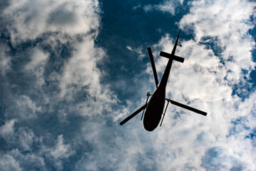 helicopter silhouette in dark clouds