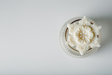 Light beige candle snowflake. Cozy home concept. Cotton dried grass, Glass vase. White background.