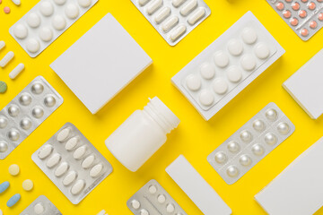 Flat lay with different pills in blister packaging and boxes and on color background