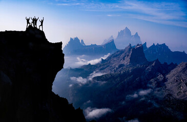 The triumph of four professional climbers at the top of mystical and extraordinary mountains - obrazy, fototapety, plakaty