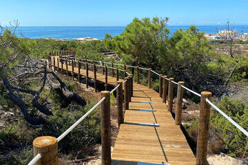 Fototapeta na wymiar Wooden boardwalk leading to the beach on the island of Sardinia