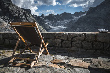 Mountain Tranquility: Deck Chair Overlooking Glacial Peaks