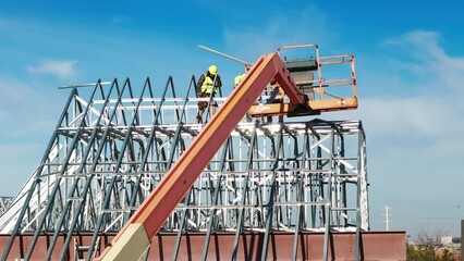 Industrial roof, roofers installing a roof on an industrial building or warehouse. Drone footage