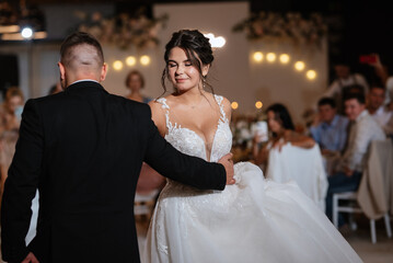 the first dance of the bride and groom inside a restaurant