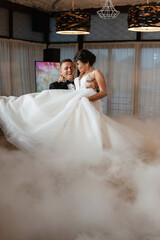 Fototapeta premium the first dance of the bride and groom inside a restaurant