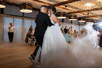 the first dance of the bride and groom inside a restaurant