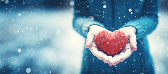 Woman Holding in Hands Red Heart in Winter Snowy Day