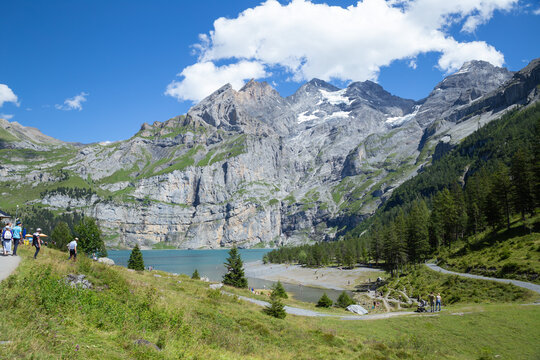 panoramic view of Oeschinen Lake with rocky mountain in the background, Kandersteg, Switzerland