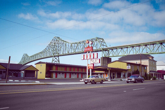 Astoria, Oregon, USA - May 12, 1992 - Grainy archival film photo of the old Dunes Motel and Astoria bridge over the Columbia river. 
