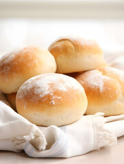 Close up of fresh baked dinner roll buns on a table, blurry bright background