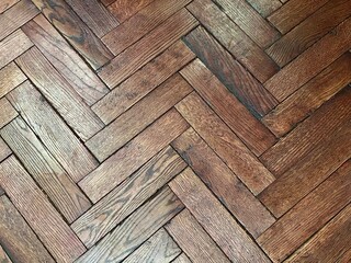 Old parquet floor close-up, top view. Paint and varnish are peeling off the wooden planks. View...