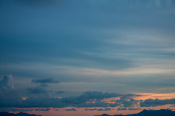 Cinematic romantic warm sky with sunset pastel clouds illuminated by last sun rays before sunset