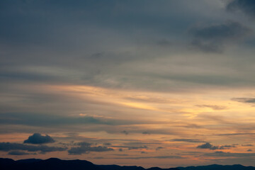 Cinematic romantic warm sky with sunset pastel clouds illuminated by last sun rays before sunset